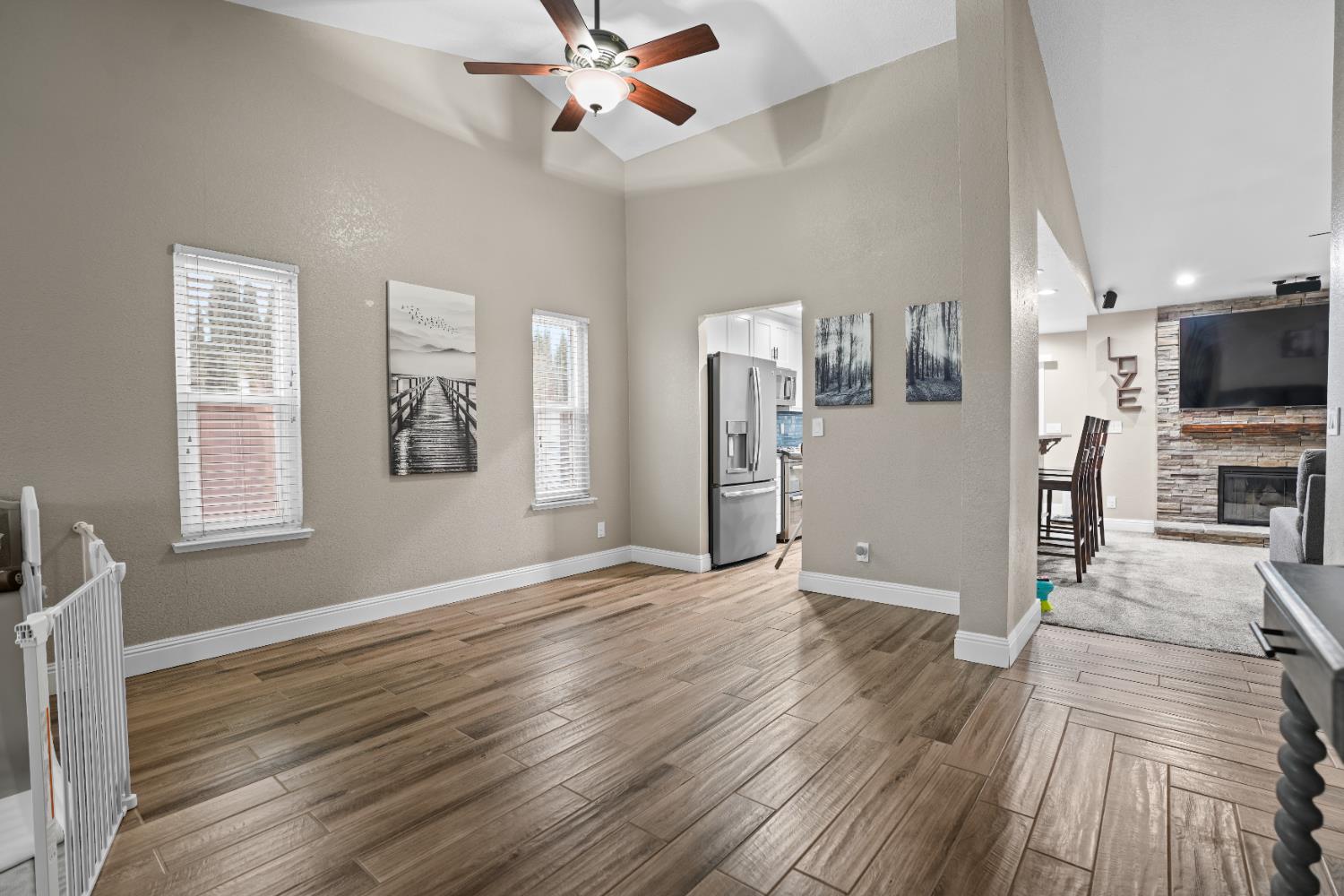 5125 Amaro Way Salida, CA 95368 - Photo 5 of 37 a view of a livingroom with wooden floor a ceiling fan and windows