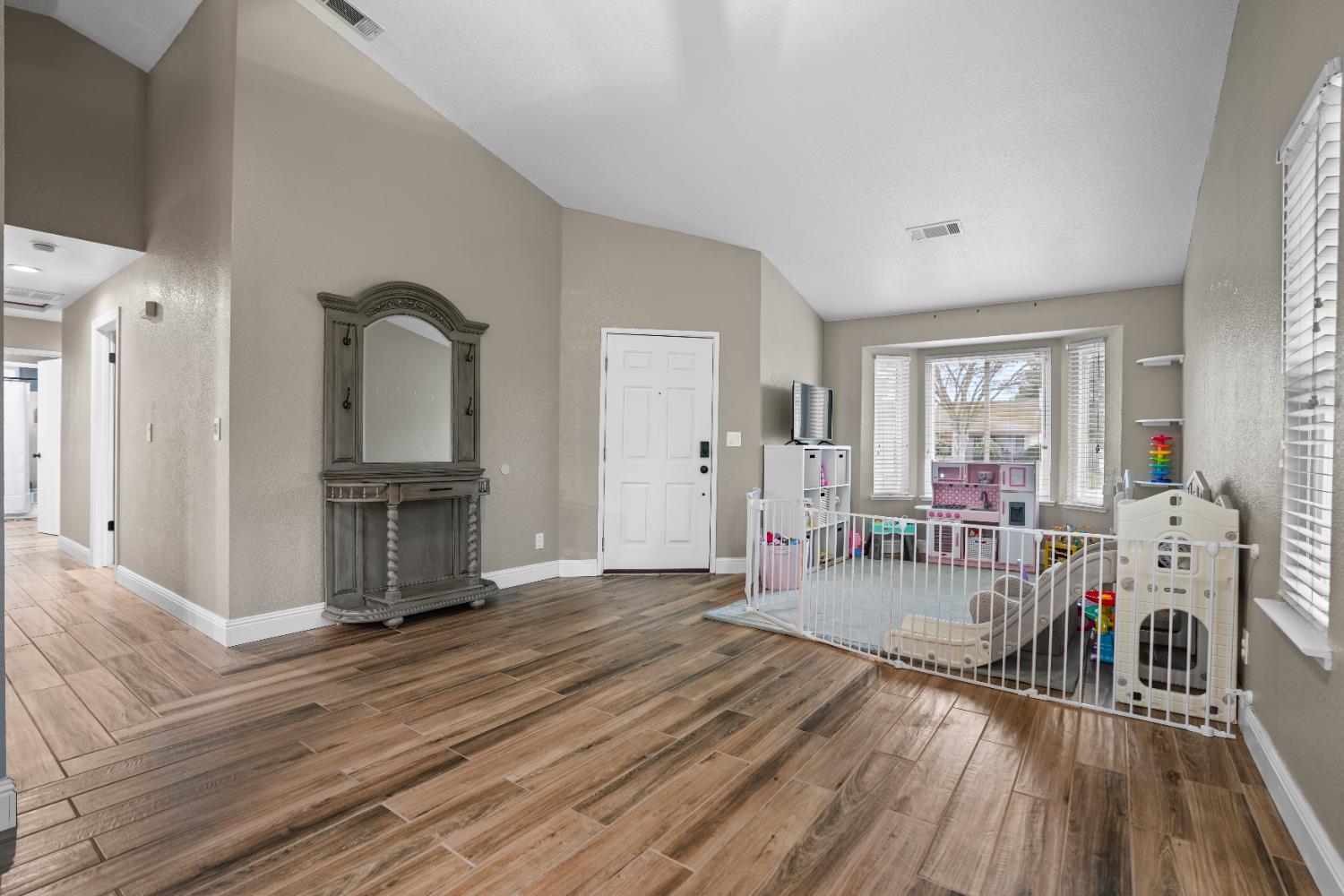 5125 Amaro Way Salida, CA 95368 - Photo 7 of 37 a living room with furniture a wooden floor and a fireplace