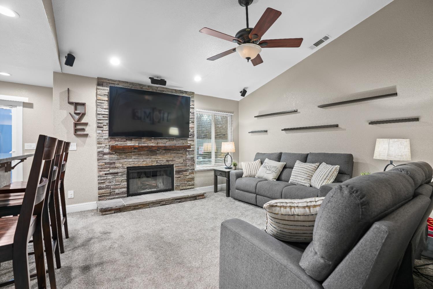5125 Amaro Way Salida, CA 95368 - Photo 8 of 37 a living room with furniture a fireplace and a flat screen tv