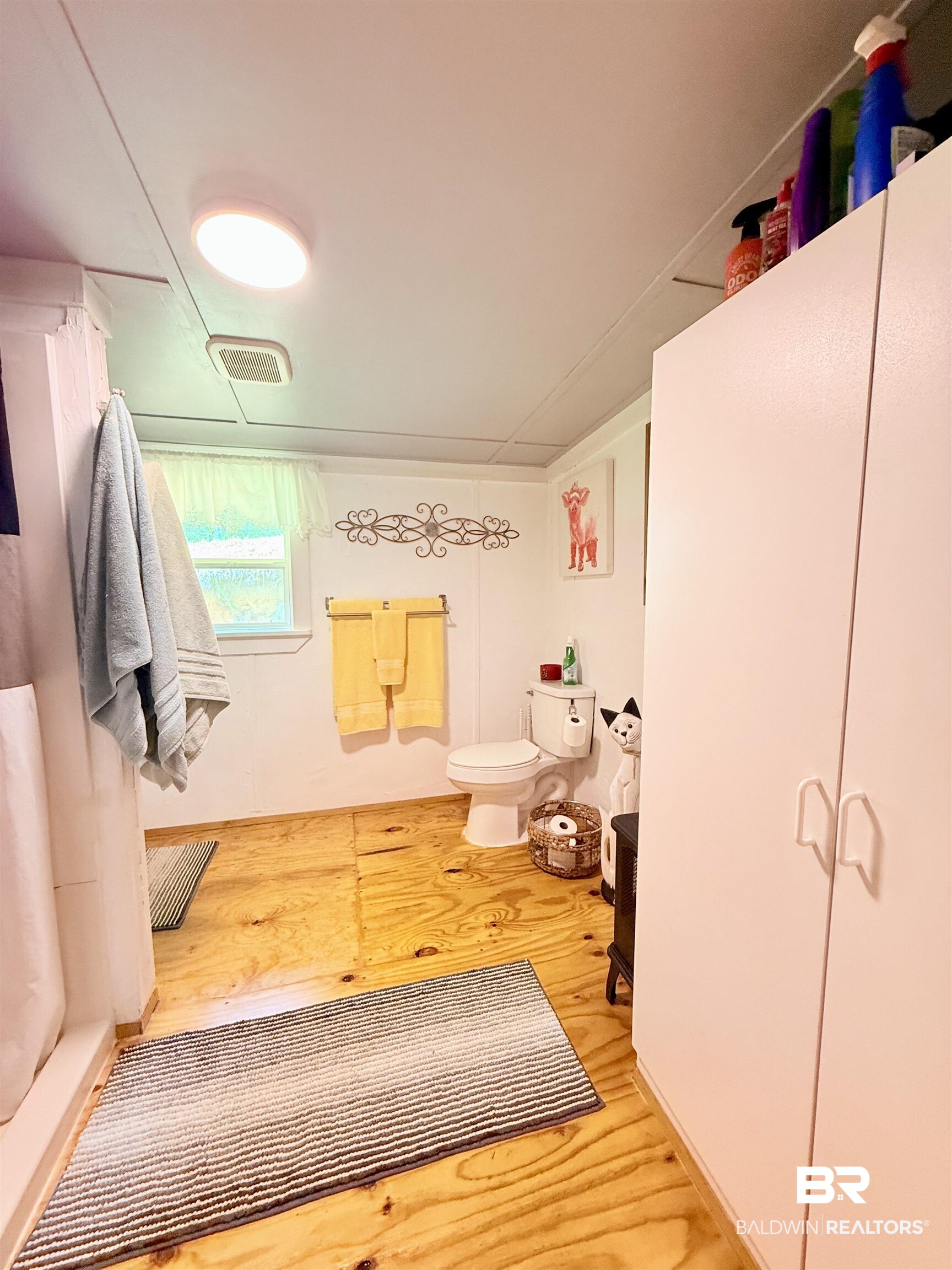 21305 River Road Robertsdale, AL 36567 - Photo 12 of 50 Bathroom with wood finished floors and toilet