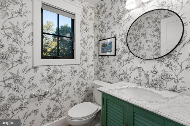 a bathroom with a toilet sink and mirror
