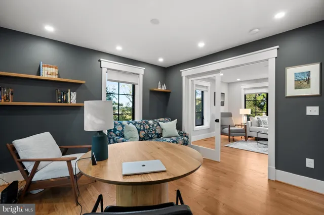 a living room with kitchen island furniture and a wooden floor