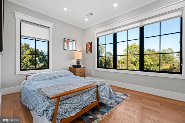 a bedroom with a bed and a large window