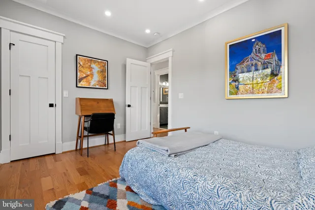 a bedroom with bed and a workspace