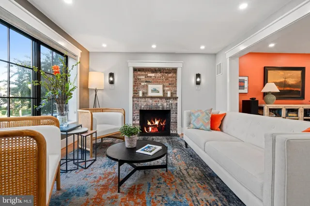 a living room with furniture a rug and a fireplace