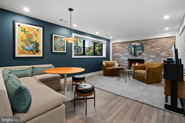 a living room with furniture ceiling fan and a rug
