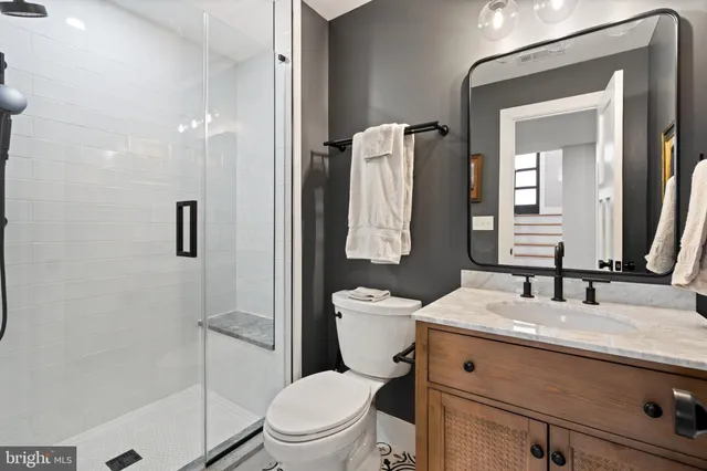 a bathroom with a toilet sink and shower