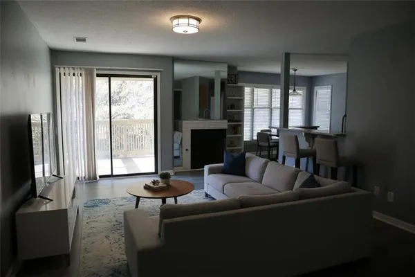 a living room with fireplace furniture and a flat screen tv