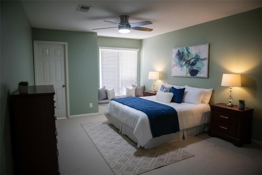 1103 Garden Court Atlanta, GA 30328 - Photo 3 of 17 a spacious bedroom with a bed and a lamp on dresser