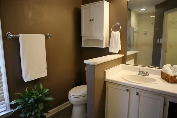 a bathroom with a sink toilet and mirror