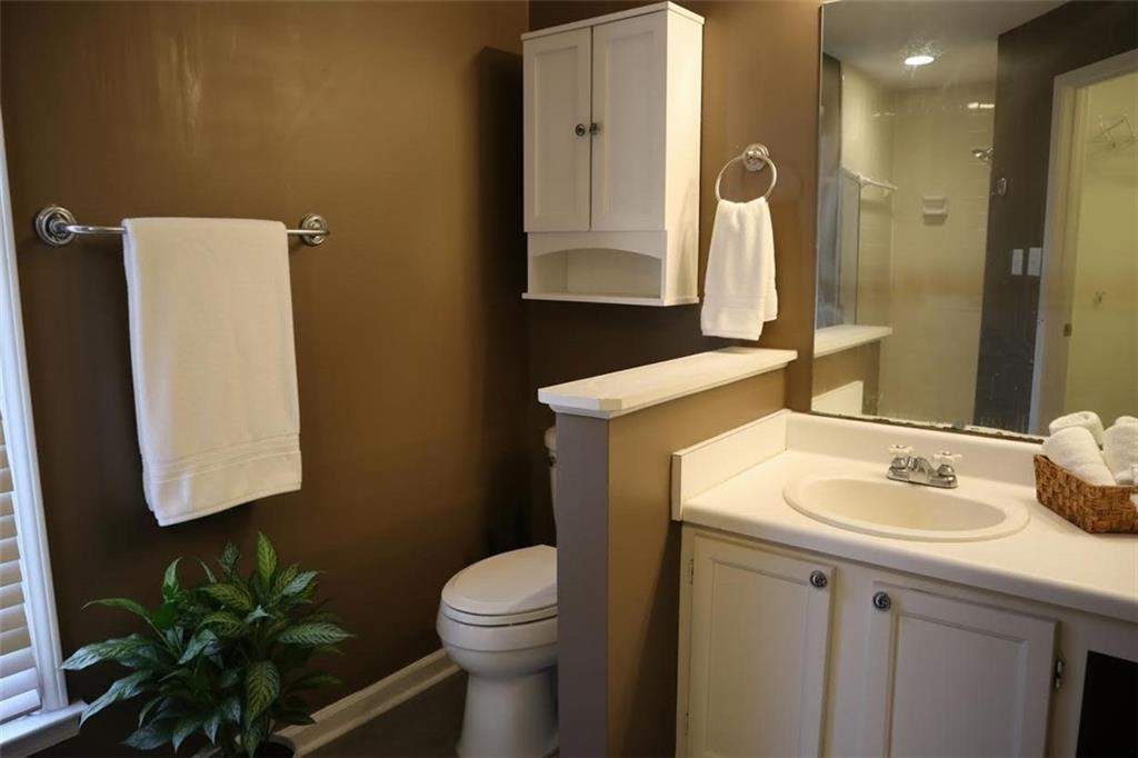 1103 Garden Court Atlanta, GA 30328 - Photo 5 of 17 a bathroom with a sink toilet and mirror