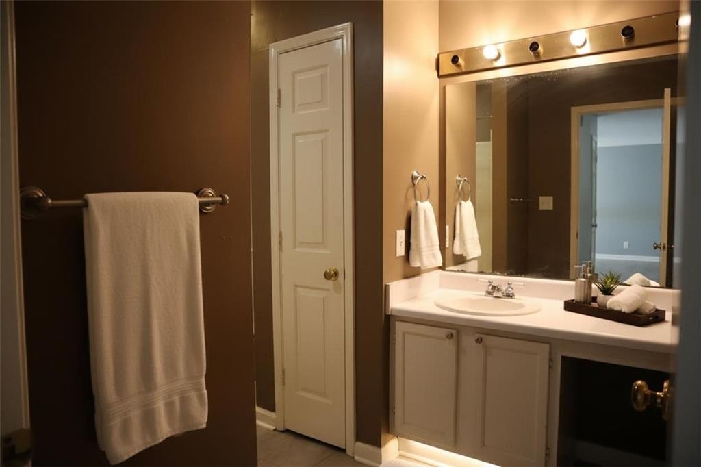 1103 Garden Court Atlanta, GA 30328 - Photo 10 of 17 a bathroom with a sink and a mirror