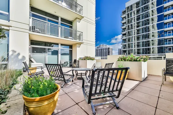 a view of a chairs and table in the balcony
