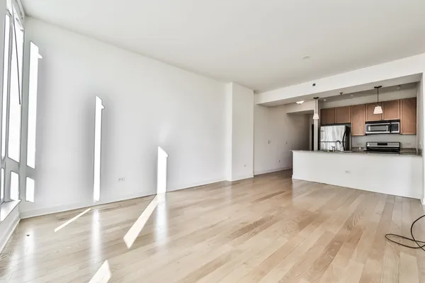 a view of a livingroom with kitchen and furniture