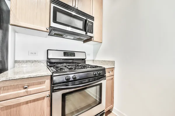 a stove top oven sitting inside of a kitchen