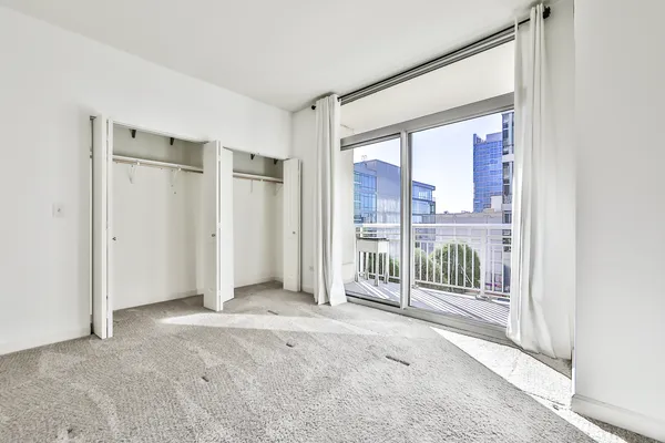 an empty room with floor to ceiling window