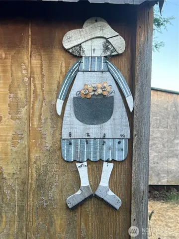 a room with water heater and wooden cabinets