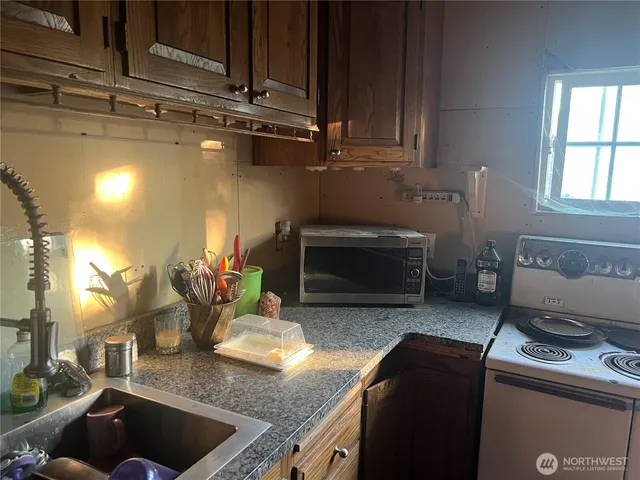 a kitchen with a stove and a microwave