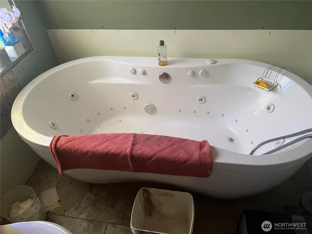 a white bath tub sitting in a bathroom