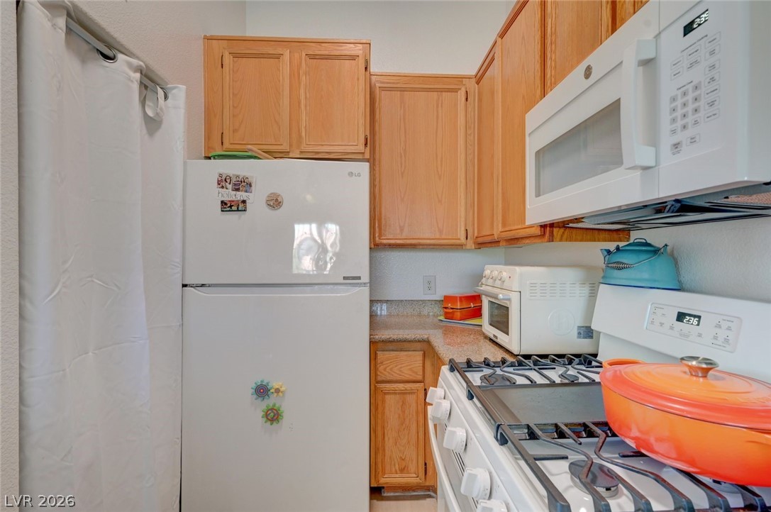 3318 North Decatur Boulevard, Unit 2072 Las Vegas, NV 89130 - Photo 10 of 50 Functional kitchen with ample cabinetry and essential appliances for everyday living.