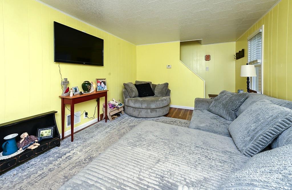 825 Childs Avenue Monaca, PA 15061 - Photo 14 of 35 a living room with furniture and a flat screen tv