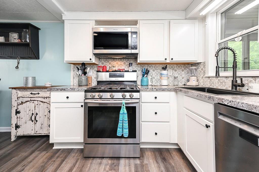 825 Childs Avenue Monaca, PA 15061 - Photo 24 of 35 a kitchen with white cabinets stainless steel appliances and sink