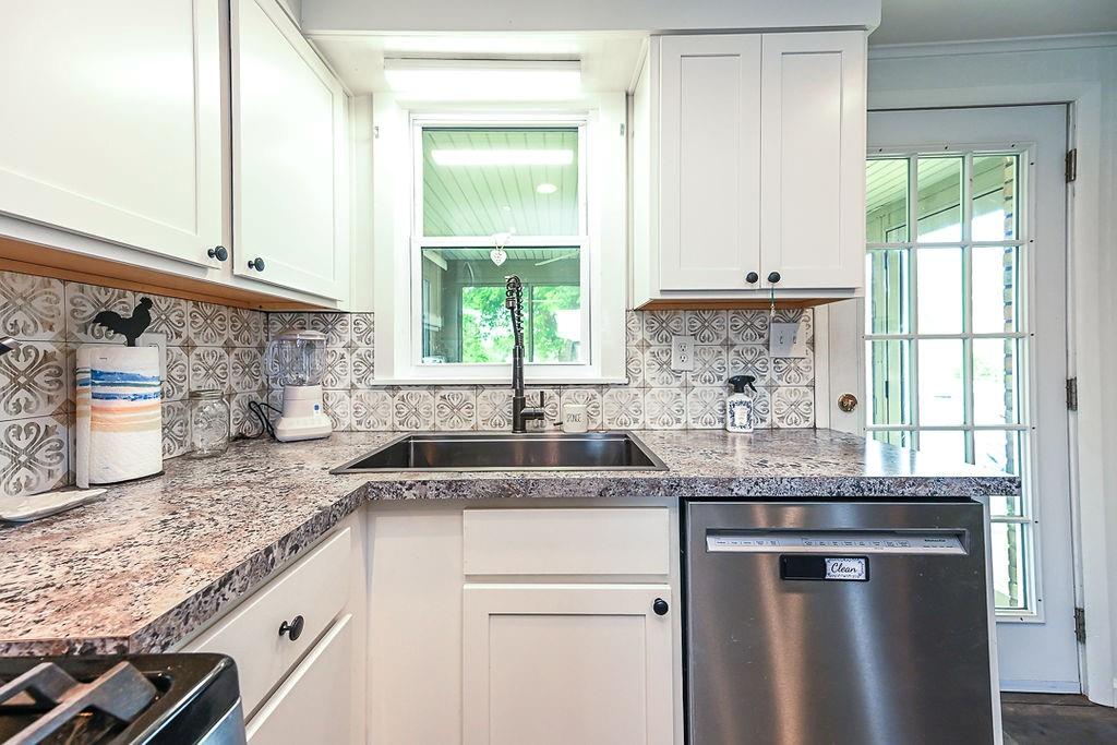 825 Childs Avenue Monaca, PA 15061 - Photo 26 of 35 a kitchen with granite countertop a sink window and cabinets