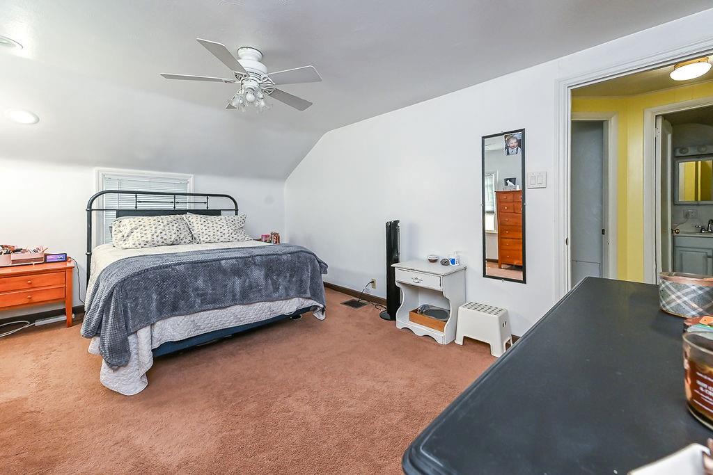 825 Childs Avenue Monaca, PA 15061 - Photo 29 of 35 a bedroom with a bed and a chandelier