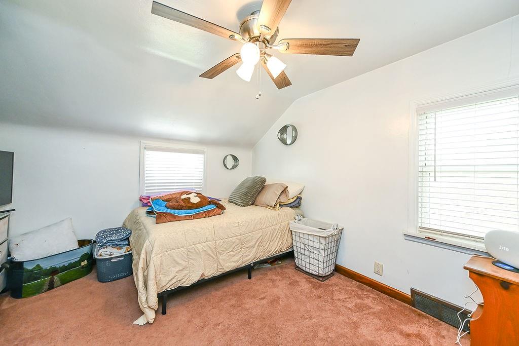 825 Childs Avenue Monaca, PA 15061 - Photo 31 of 35 a bedroom with a bed a chandelier and a window