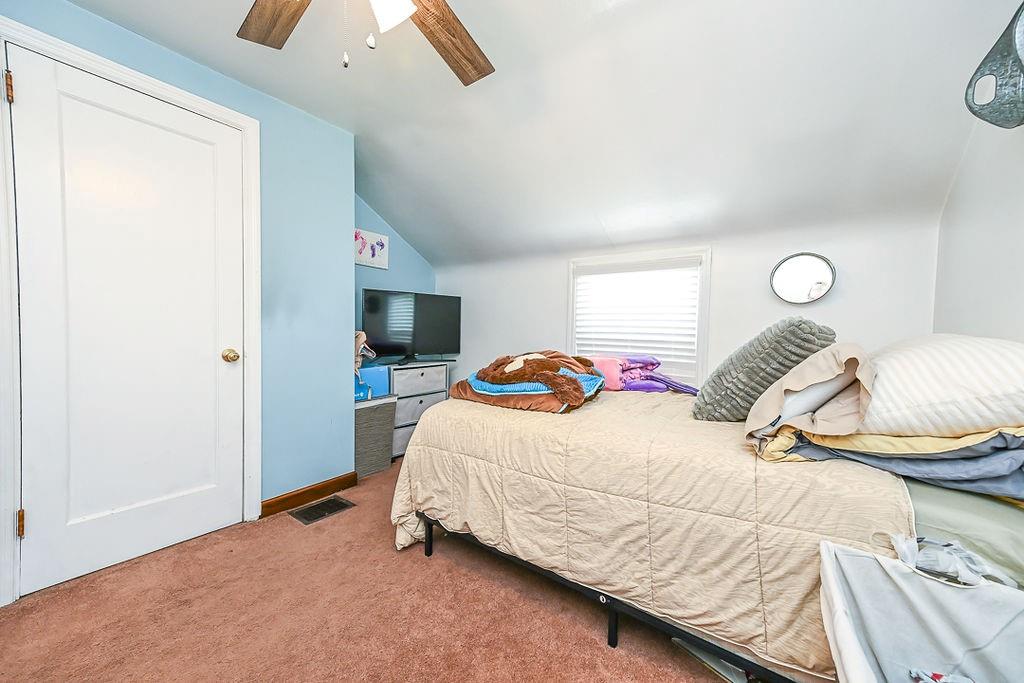 825 Childs Avenue Monaca, PA 15061 - Photo 32 of 35 a bedroom with a bed and a lamp