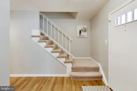 a view of entryway and hall with wooden floor