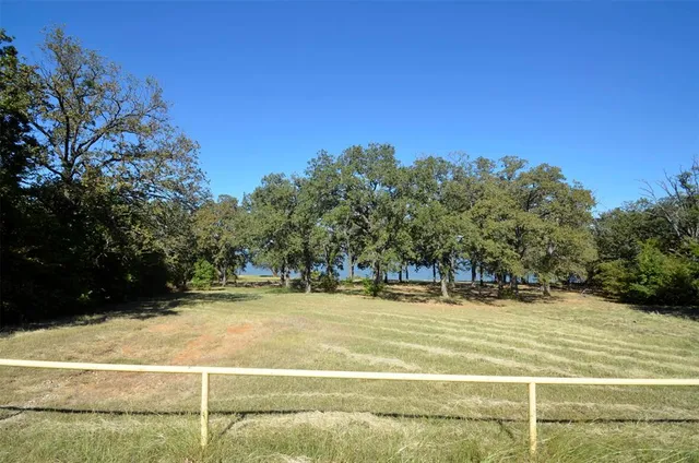 a backyard of a house with large trees