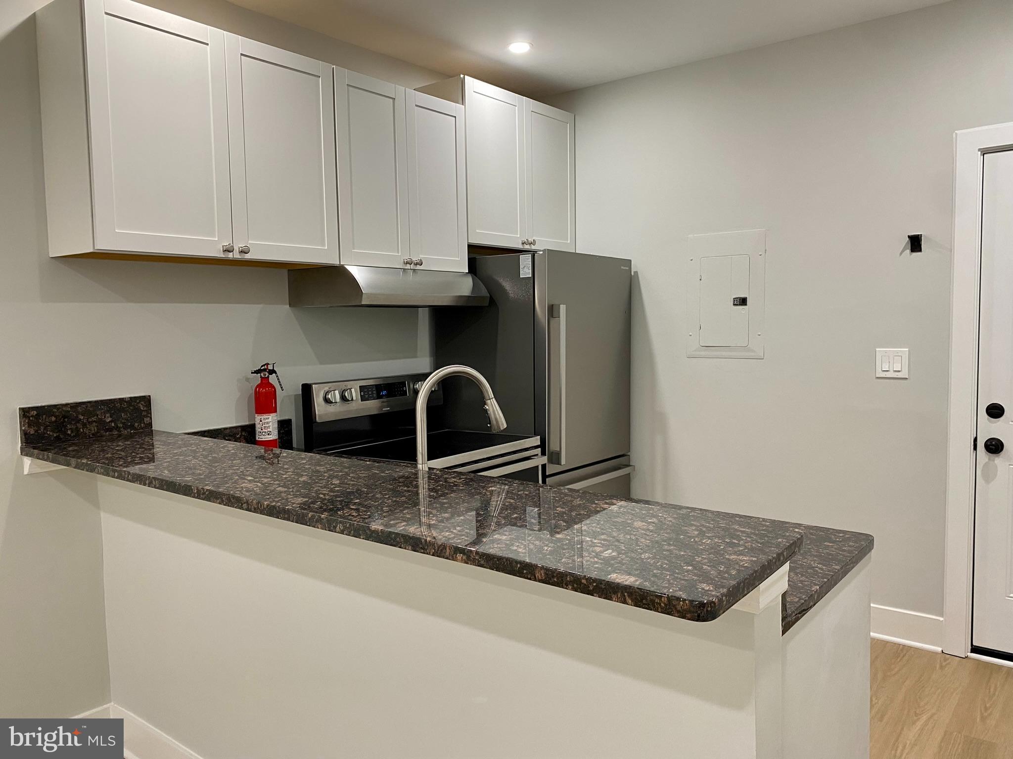 3701 9th Street Northwest, Unit 4 Washington, DC 20010 - Photo 2 of 19 a kitchen with stainless steel appliances granite countertop a sink refrigerator and cabinets