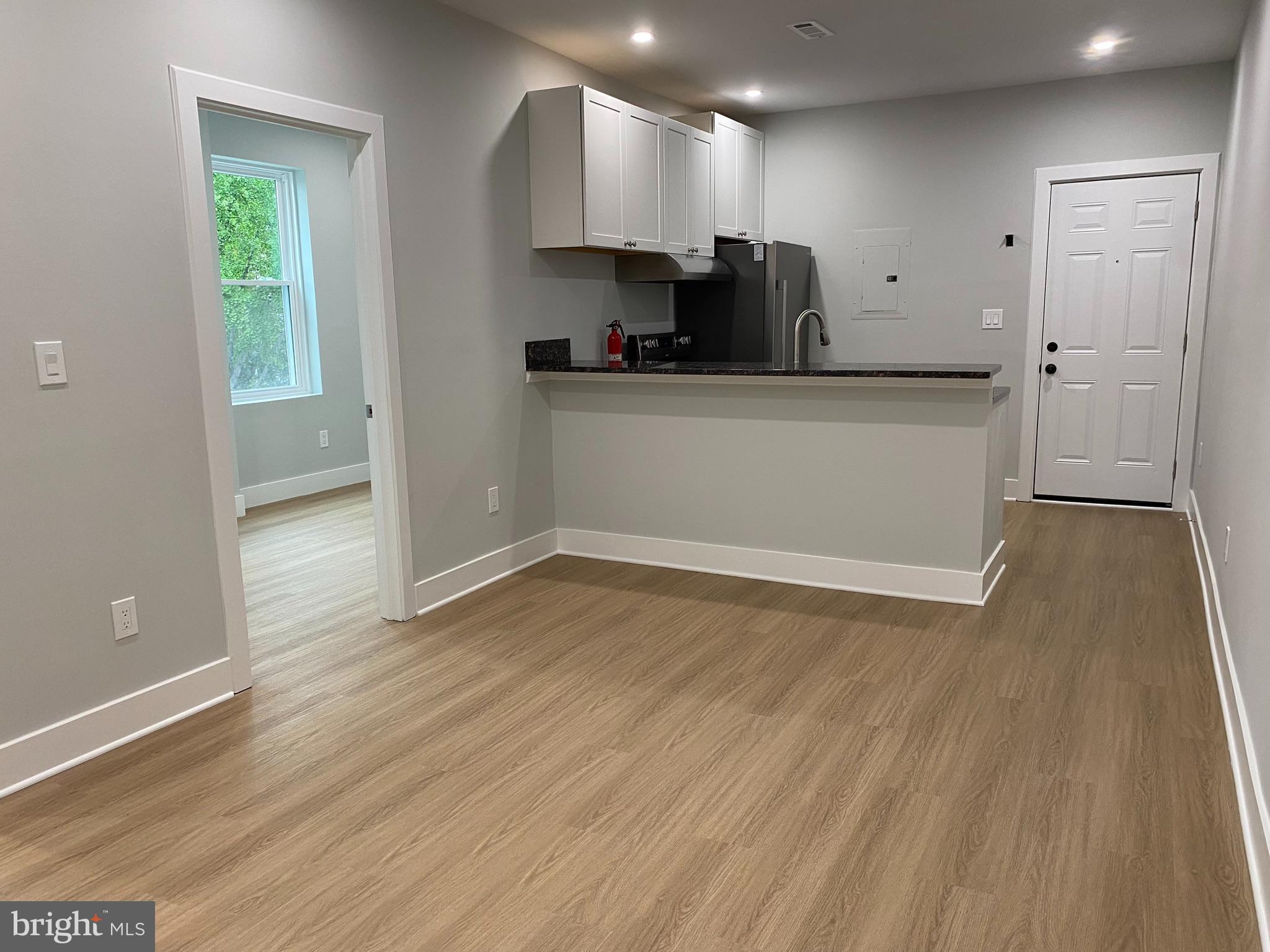 3701 9th Street Northwest, Unit 4 Washington, DC 20010 - Photo 5 of 19 a kitchen with granite countertop a sink cabinets and wooden floor