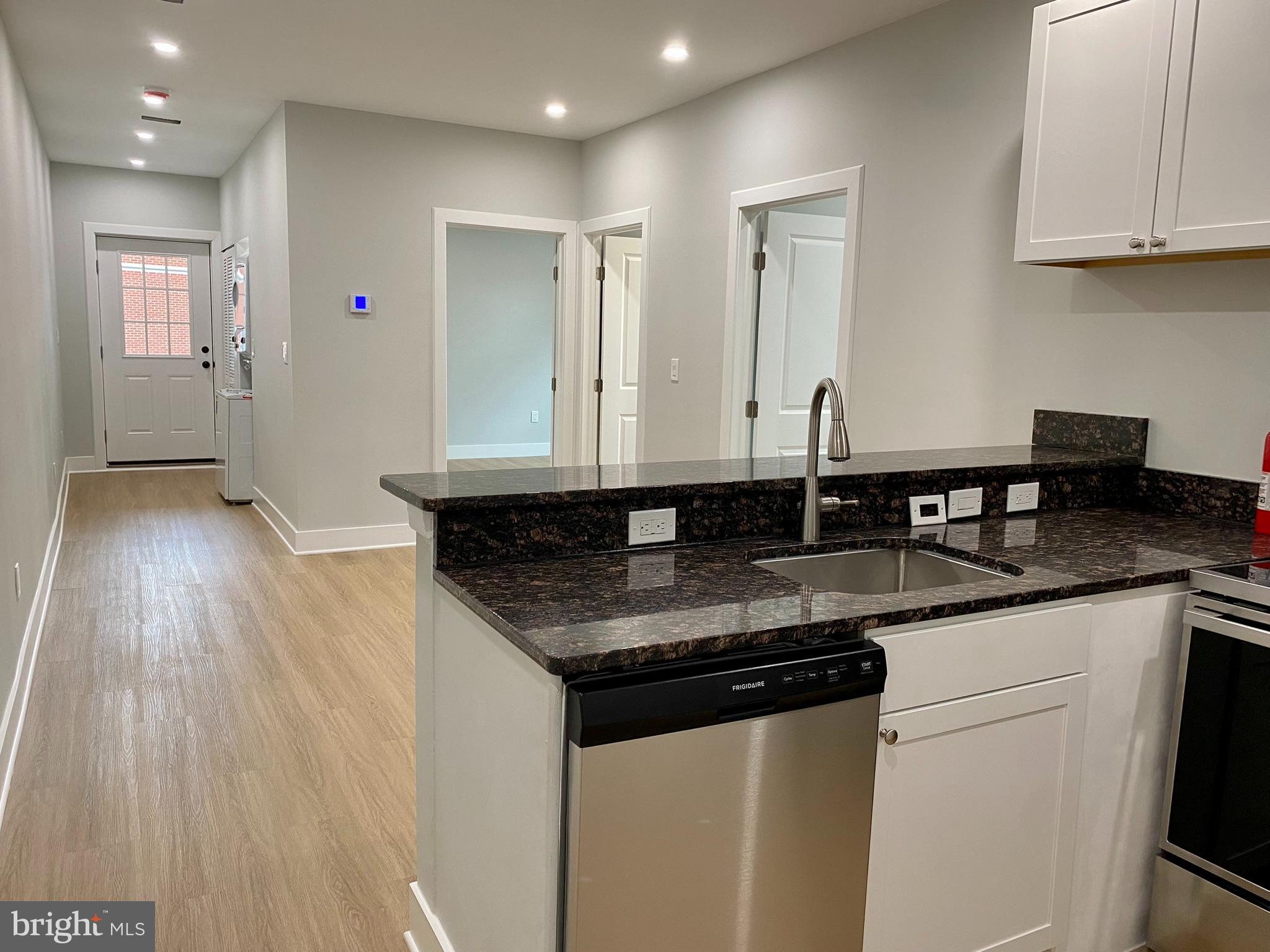3701 9th Street Northwest, Unit 4 Washington, DC 20010 - Photo 7 of 19 a kitchen with granite countertop a sink and cabinets