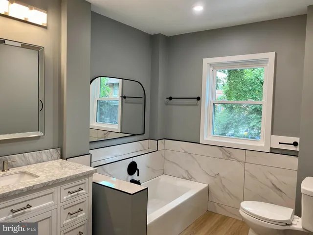 a bathroom with a sink and a window