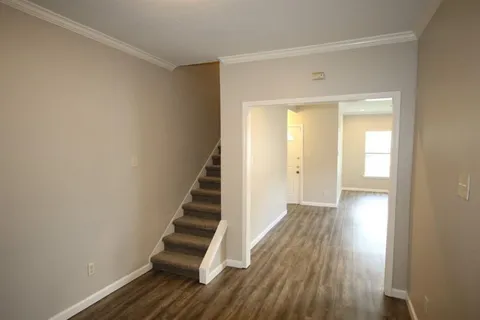 a view of a room with wooden floor and a window