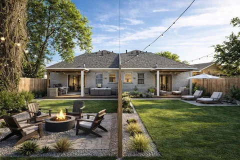 a view of a backyard with wooden fence and a large tree
