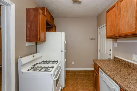 a kitchen with a stove and a refrigerator