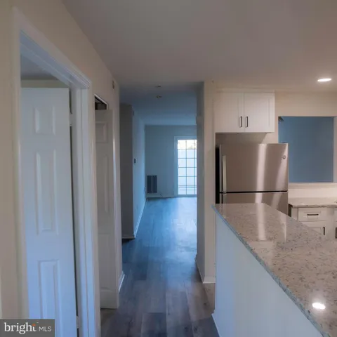 a view of a kitchen with a sink and a refrigerator
