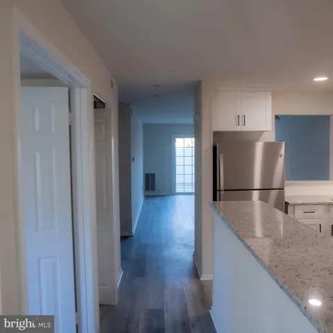 a view of a kitchen with a sink and a refrigerator