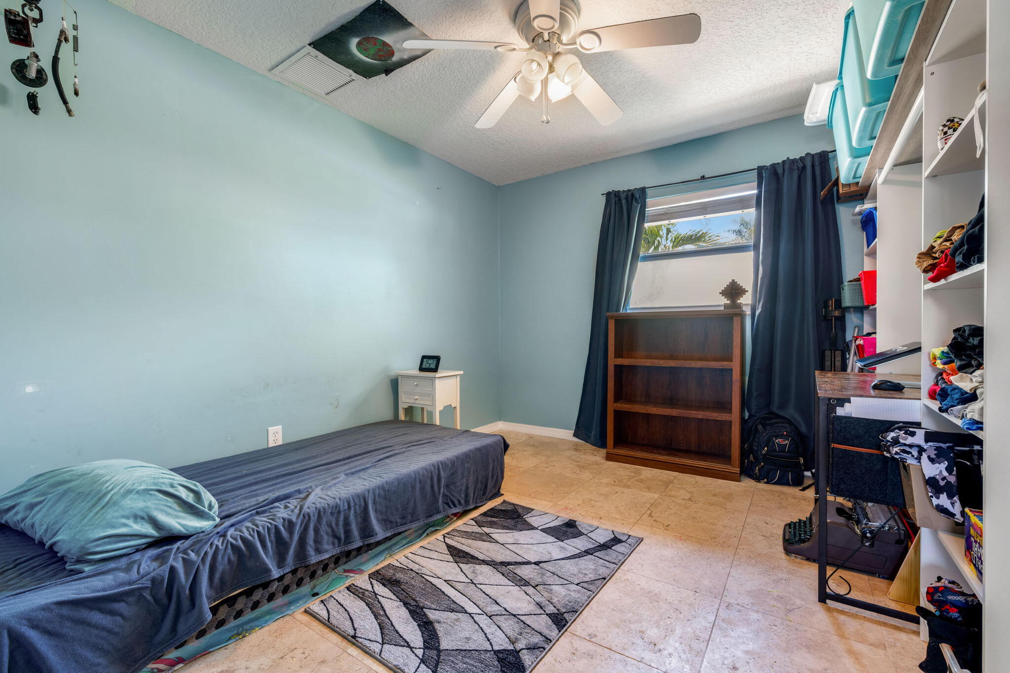1216 Neoga Street Jupiter, FL 33458 - Photo 13 of 27 a bedroom with furniture and a chandelier