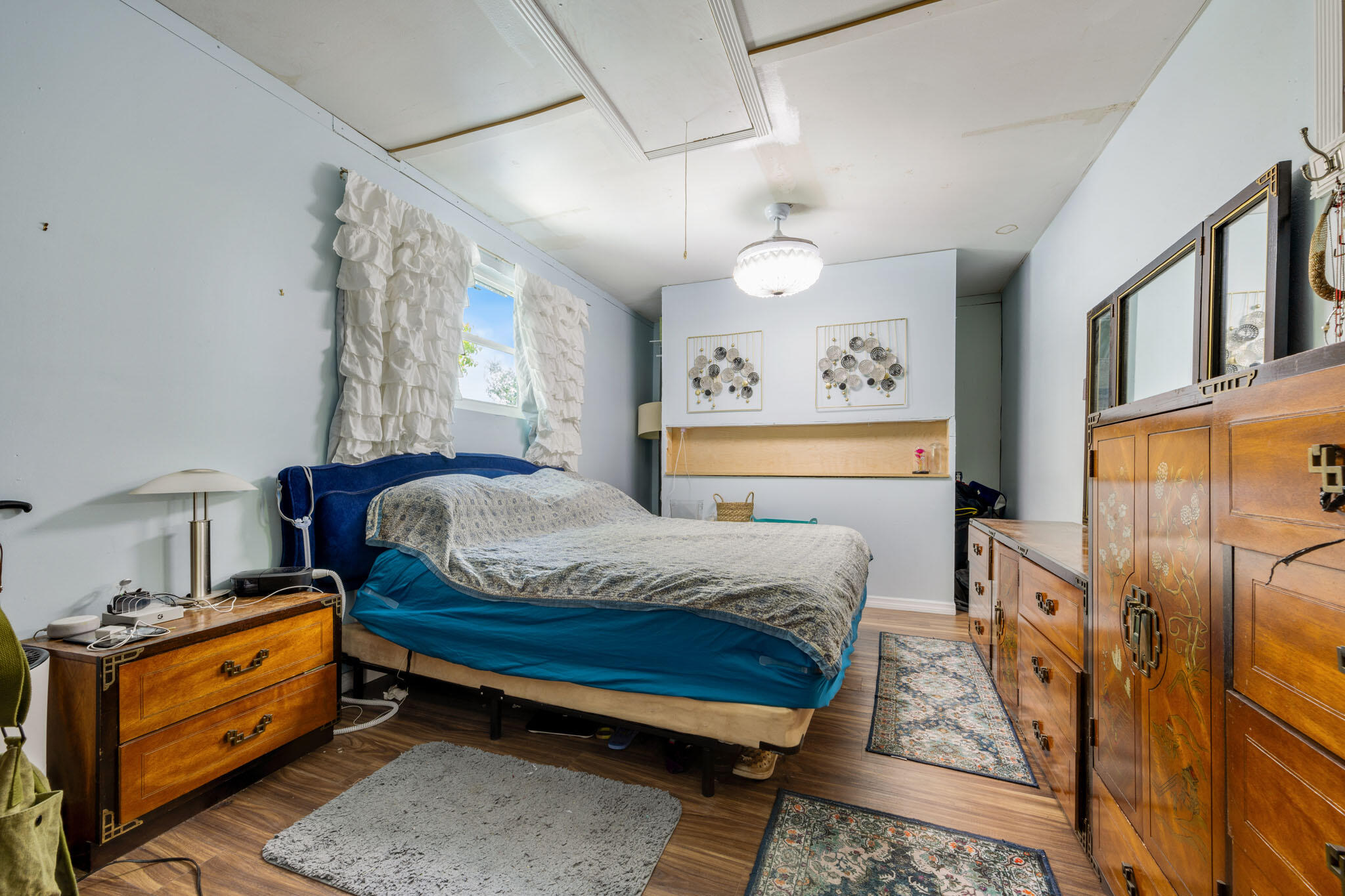 1216 Neoga Street Jupiter, FL 33458 - Photo 16 of 27 a bedroom with a bed and wooden floor