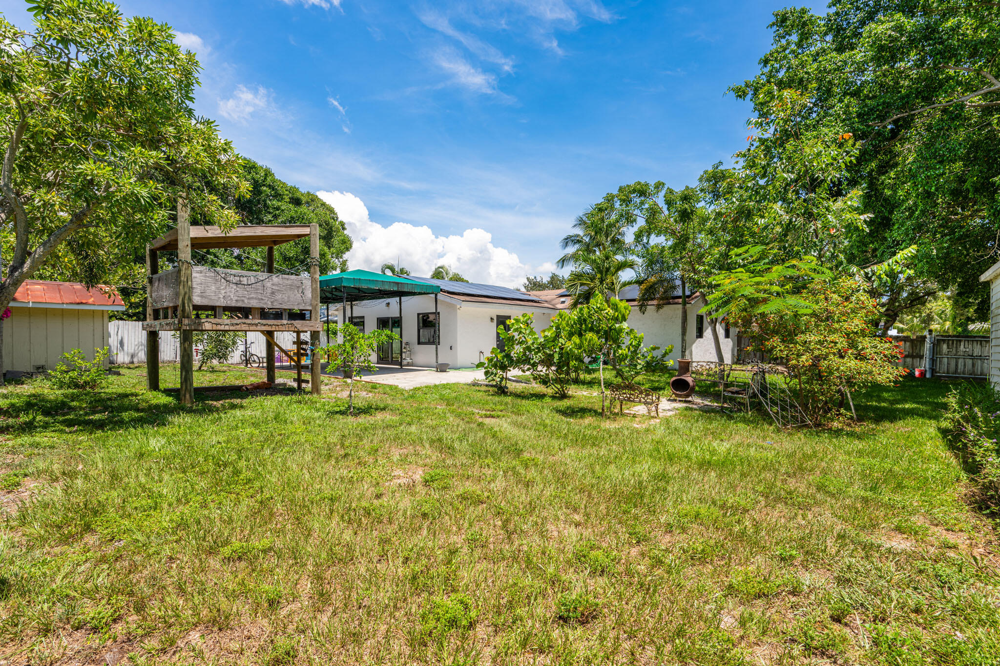 1216 Neoga Street Jupiter, FL 33458 - Photo 17 of 27 a front view of a house with a yard