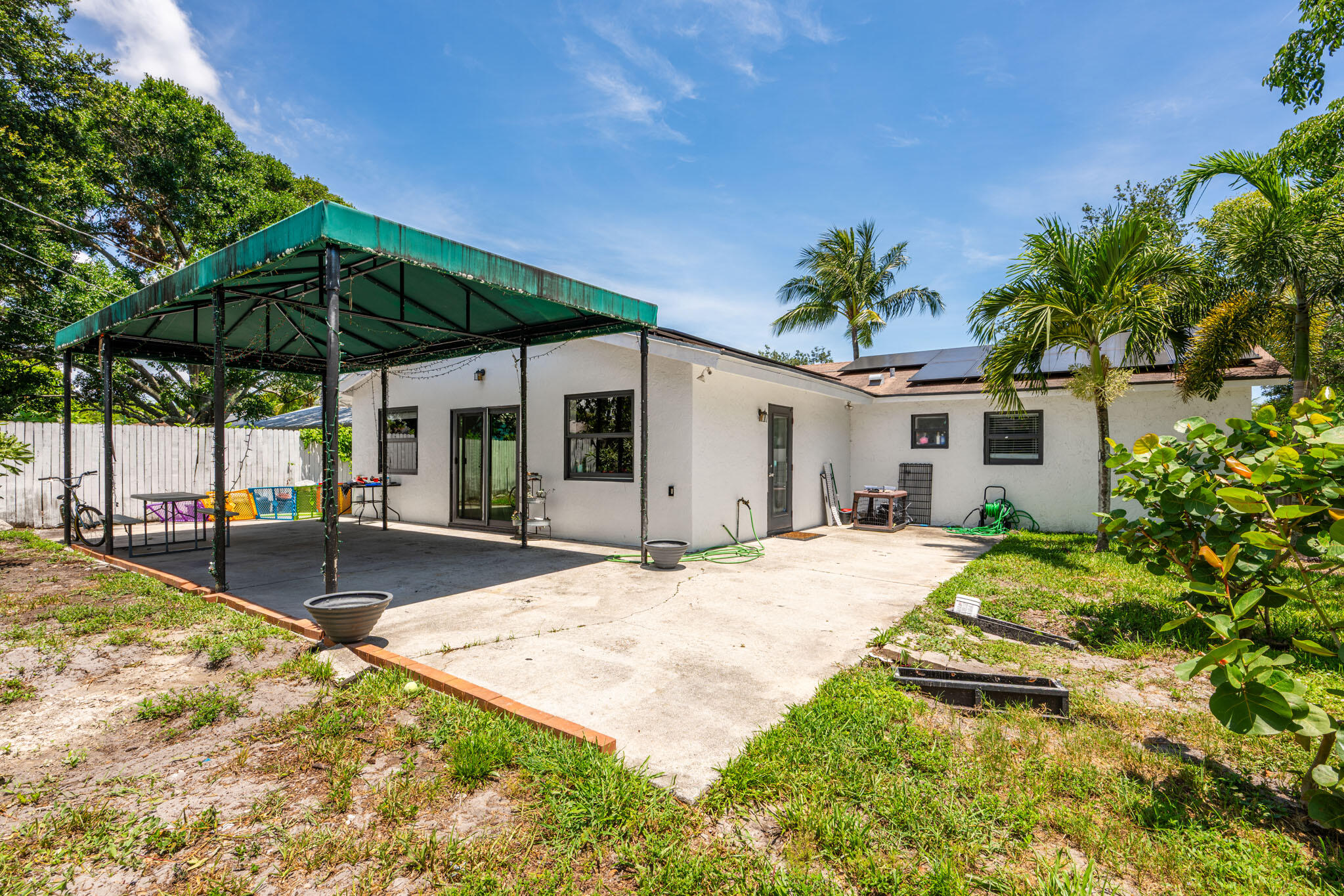 1216 Neoga Street Jupiter, FL 33458 - Photo 18 of 27 a view of a house with backyard and sitting area