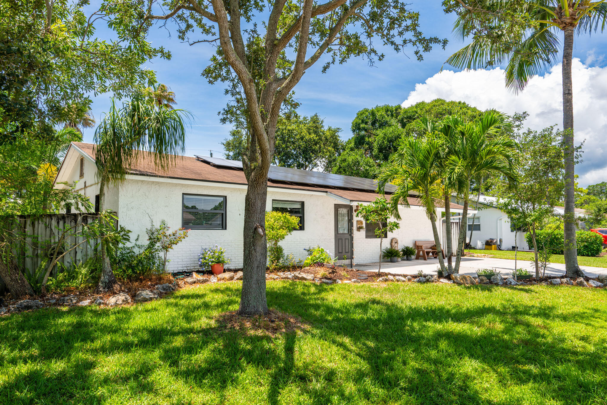 1216 Neoga Street Jupiter, FL 33458 - Photo 25 of 27 a view of a house with backyard and sitting area