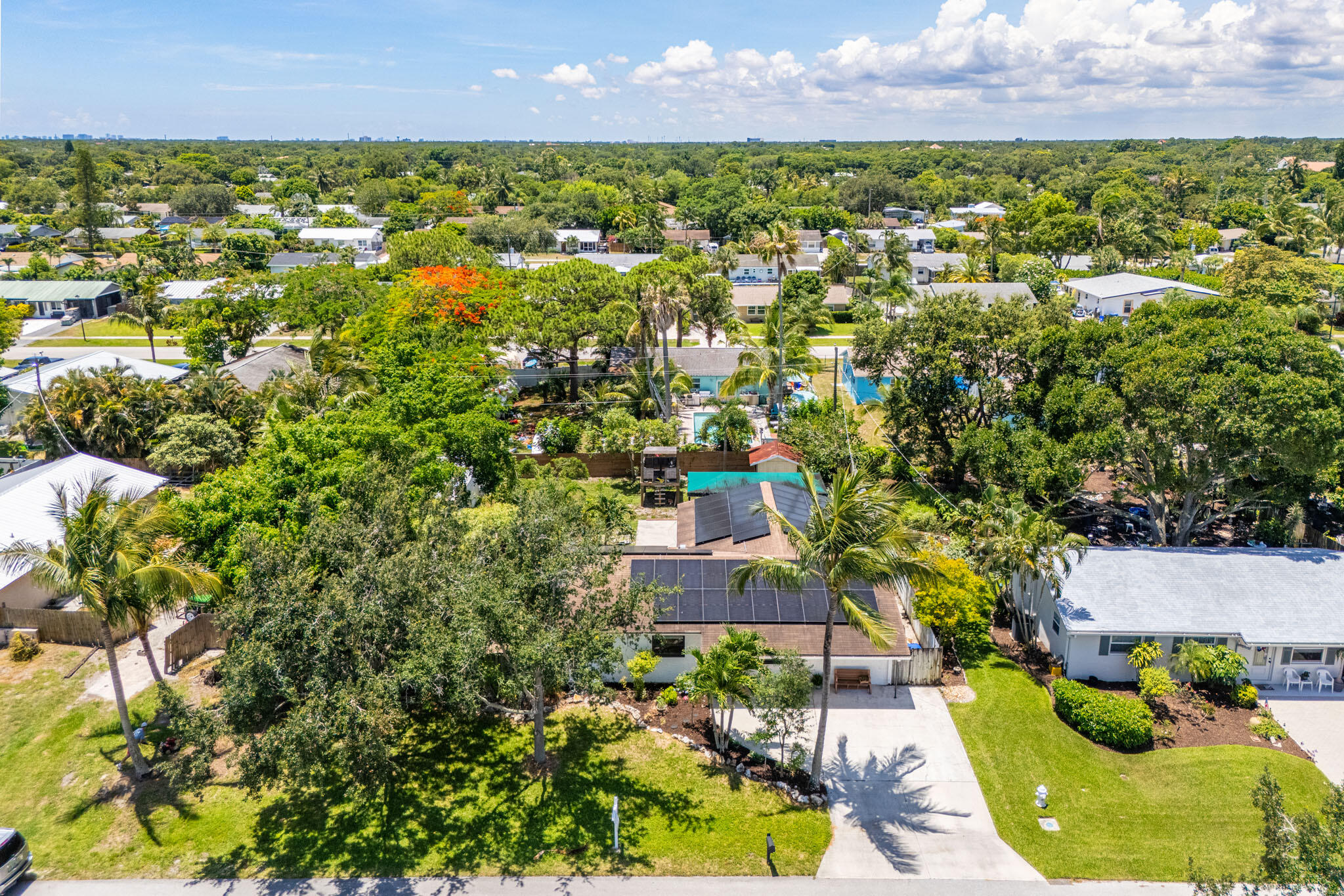 1216 Neoga Street Jupiter, FL 33458 - Photo 26 of 27 an aerial view of residential houses with outdoor space and trees