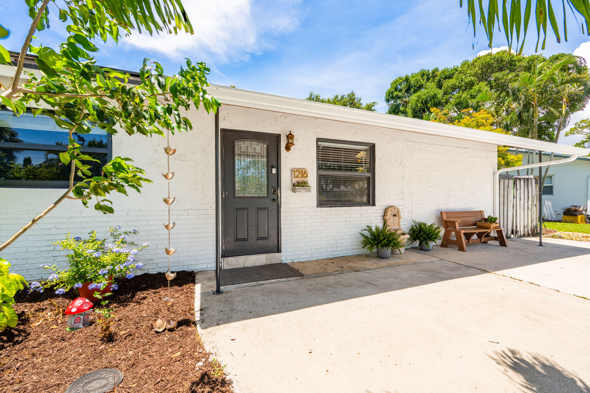1216 Neoga Street Jupiter, FL 33458 - Photo 3 of 27 a view of a backyard with a patio