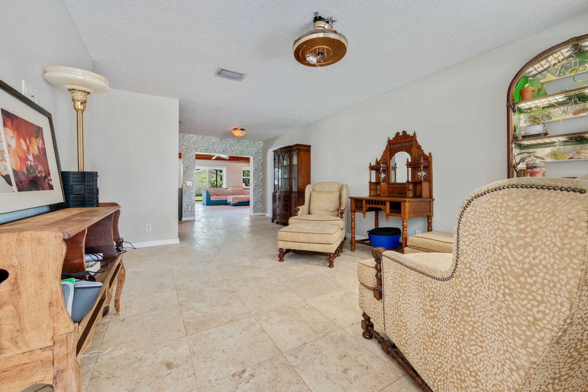 1216 Neoga Street Jupiter, FL 33458 - Photo 4 of 27 a living room with furniture and a flat screen tv