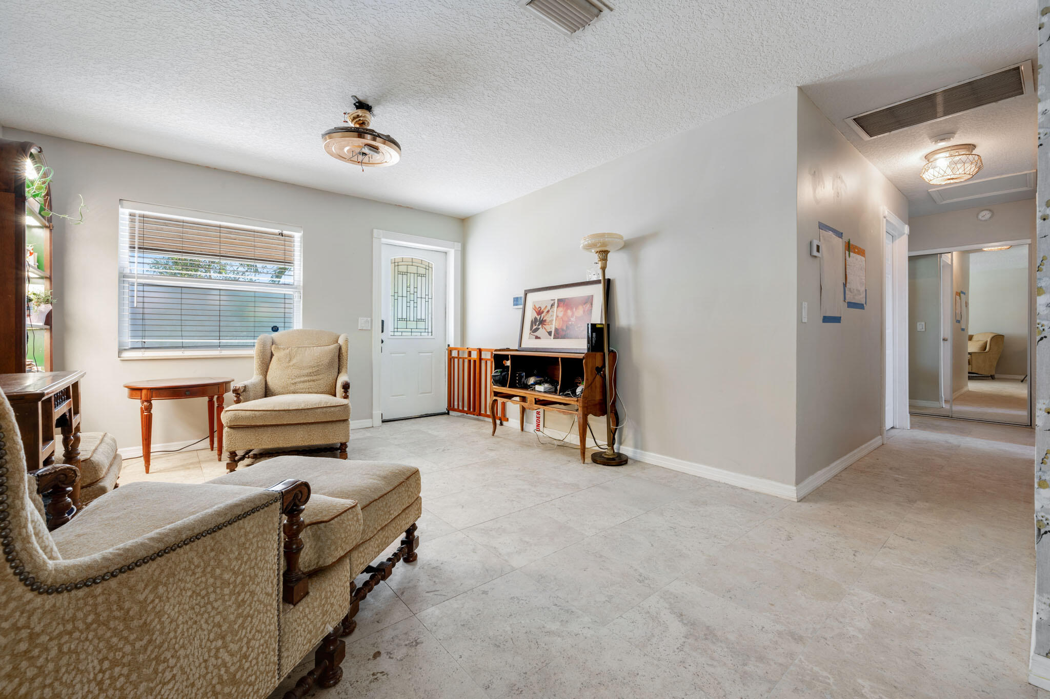 1216 Neoga Street Jupiter, FL 33458 - Photo 5 of 27 a living room with furniture and a large window